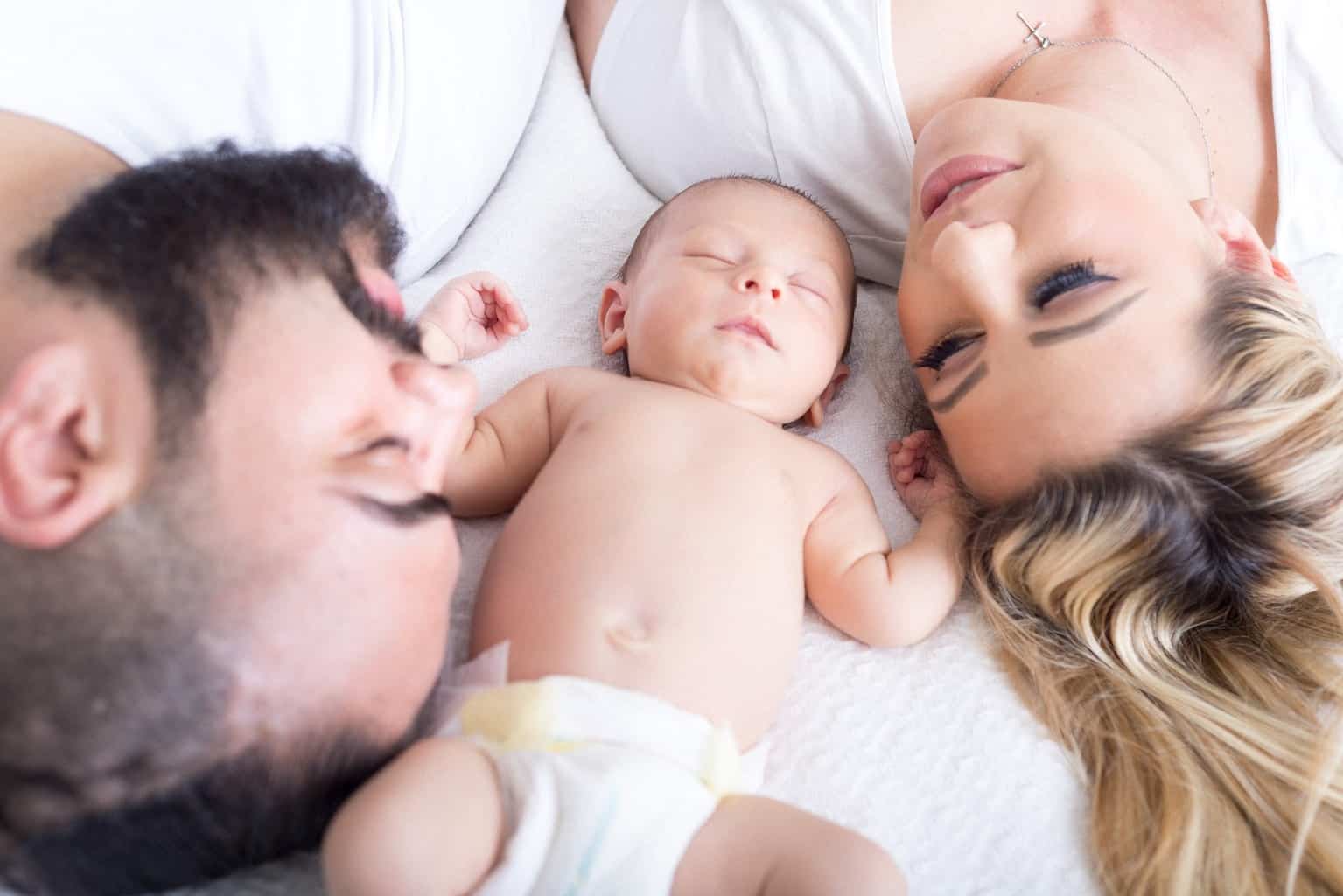 a newborn baby with mom and dad