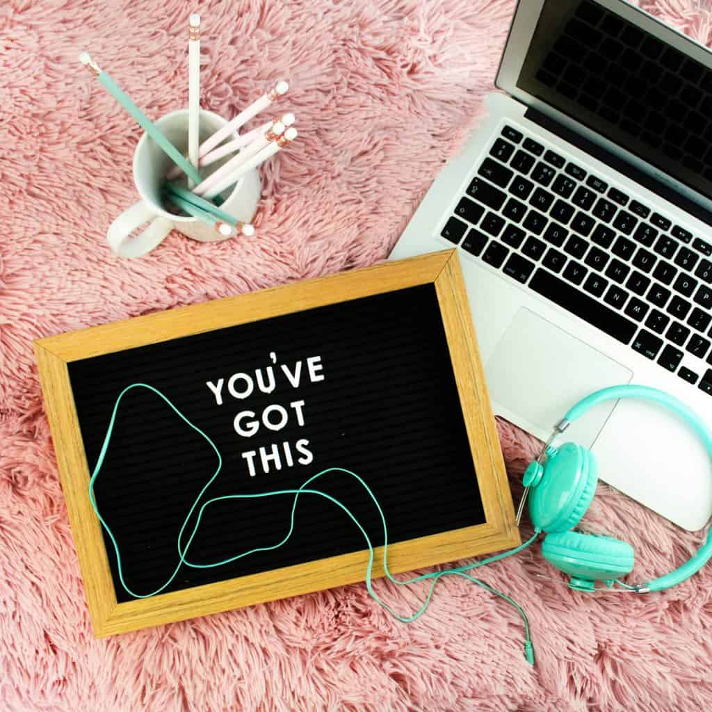 a laptop, a headphone, and a blackboard with the text 'you've got this'