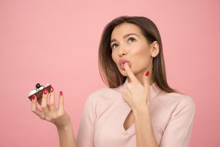 woman eating cupcake